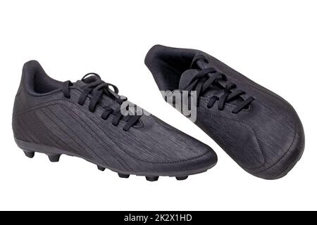 Closeup of a pair of black leather football boots isolated on white background. Professional athletics boys outdoor training shoes. Sports shoes. Stock Photo