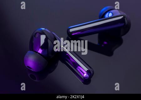 Wireless headphones on black background Stock Photo