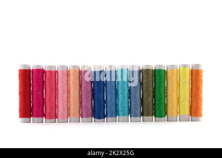 Colourful thread spools on white background with clipping path Stock Photo