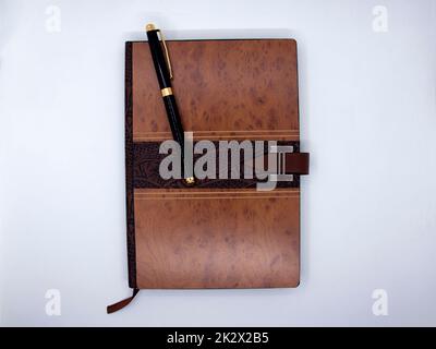 Notepad with ballpoint pen isolated on white background Stock Photo