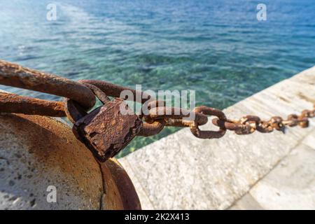 A rusted chain and an old rusty lock Stock Photo