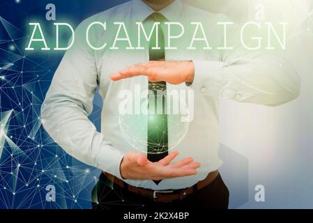 Hand writing sign Ad Campaign. Conceptual photo promotion of specific product or service through internet Businessman holding open palms represents global innovative thinking. Stock Photo
