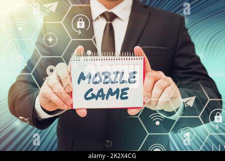 Sign displaying Mobile Game. Concept meaning they are entertaining programs made to work on smart device Businessman in suit holding notepad symbolizing successful teamwork. Stock Photo