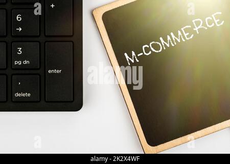 Sign displaying M Commerce. Concept meaning commercial transactions conducted electronically by mobile phone Computer Keyboard And Symbol.Information Medium For Communication. Stock Photo