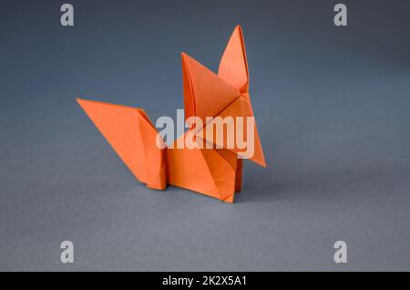 Orange paper fox origami isolated on a grey background Stock Photo