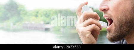 Man Using Asthma Inhaler Stock Photo