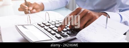 Businessman Calculating Invoice Stock Photo