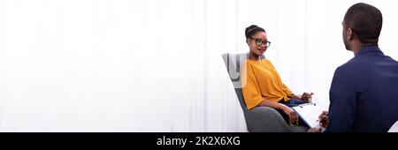 Woman Visiting Psychologist To Treat Depression Stock Photo