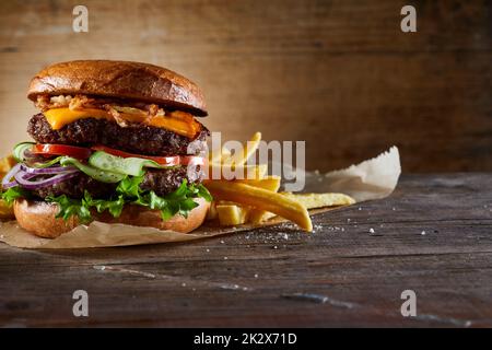 Burger with vegetables served with fries Stock Photo