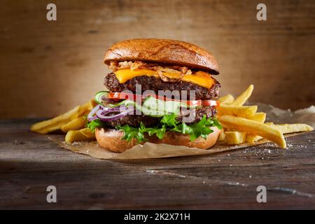 Double burger with fries on table Stock Photo