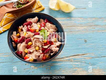 Bowl of tune salad served on table in kitchen Stock Photo