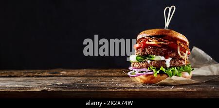 Appetizing burger on wooden table Stock Photo