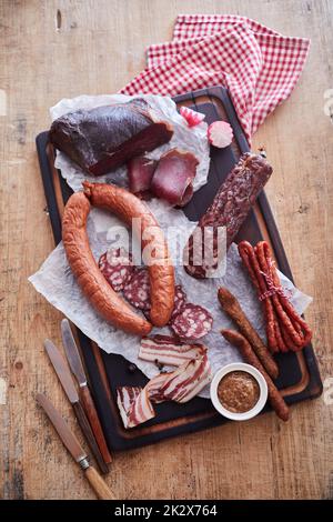 Assorted sausages served on tray Stock Photo