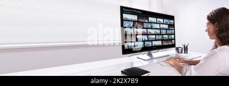 Editor Searching Photos On Computer Stock Photo