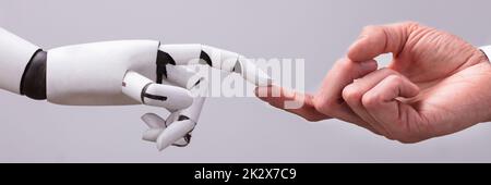 Robot Touching Human Finger Stock Photo