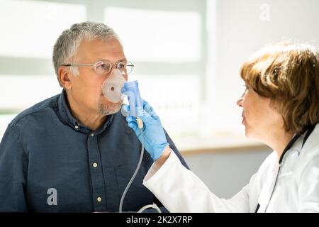 Man Using Oxygen Mask In Clinic Stock Photo