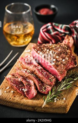 Entrecote. Steak on the bone. Rib eye. Tomahawk steak on the on a cutting board with rosemary. Roasting - Rare Stock Photo