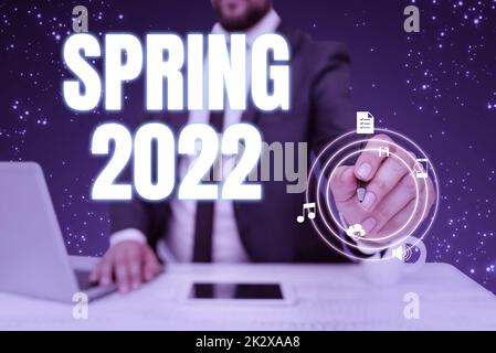 Text caption presenting Spring 2022. Word Written on time of year where flowers rise following winter season Businessman in suit holding pen representing innovative thinking.