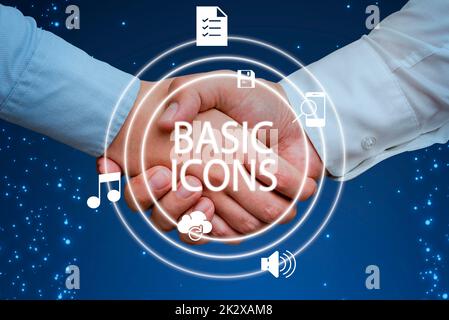 Writing displaying text Basic Icons. Business concept pictogram or ideogram displayed on a computer screen or phone Hands shaking presenting innovative plan ideas symbolizing teamwork. Stock Photo