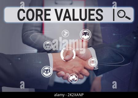 Inspiration showing sign Core Values. Internet Concept belief person or organization views as being importance Colleagues shaking hands congratulating successful teamwork. Stock Photo