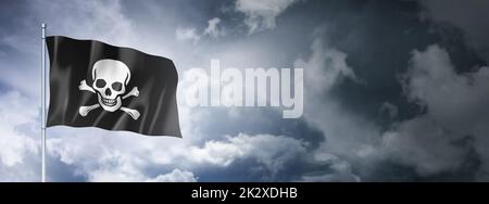 Pirate flag, Jolly Roger on a cloudy sky Stock Photo