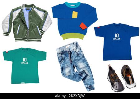 Collage set of little boys spring clothes isolated on a white background. Denim trousers or pants, sneaker, a rain jacket, jeans, shirts and a sweater for child boy. Children's summer fashion. Stock Photo
