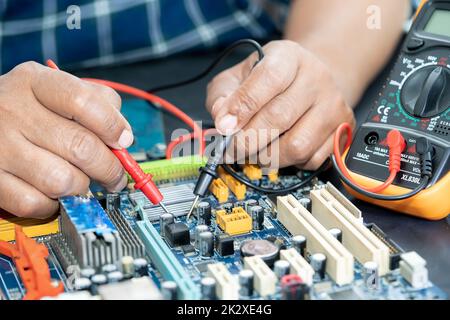 Technician repairing inside of mobile phone by soldering iron. Integrated Circuit. the concept of data, hardware, technology. Stock Photo