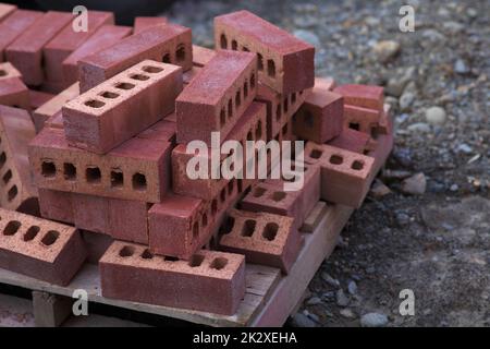bricks on pallet stacked construction stone material masonry red brickwork Stock Photo