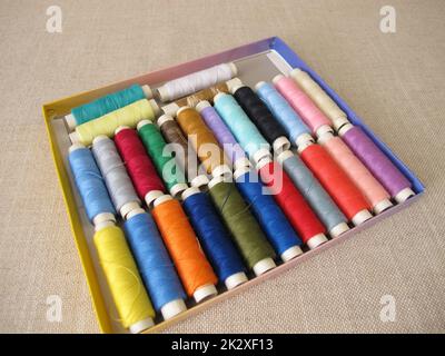 Sewing thread in different colors in a box Stock Photo