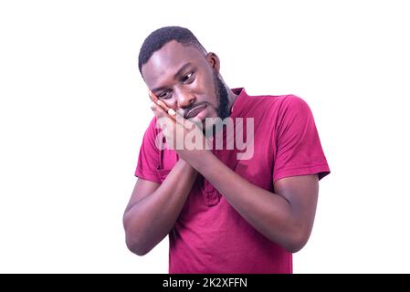 handsome calm young man, wearing red t-shirt, with hands on cheek having toothache. Stock Photo