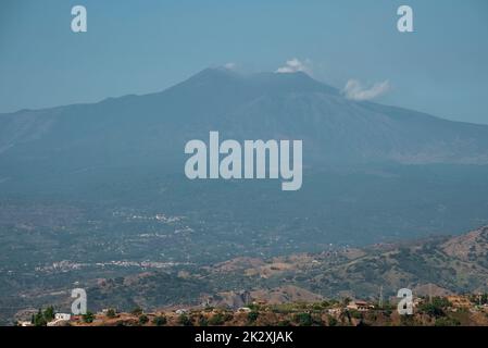 Beautiful view of majestic volcanic Mount Etna with townscape in foreground Stock Photo