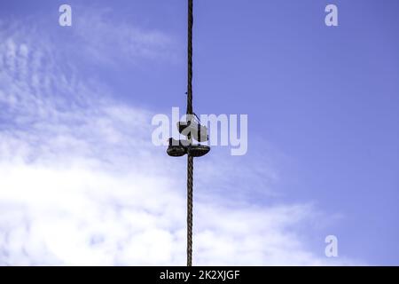 Slippers on electrical wires Stock Photo