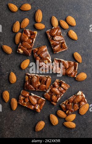 Sweet mini almond bars on black table. Stock Photo