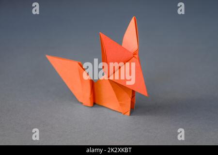 Orange paper fox origami isolated on a grey background Stock Photo