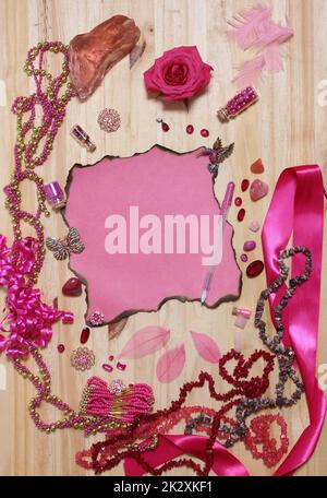 Pink and Magenta Jewelry With Rose and Blank Paper With Burned Edges Stock Photo