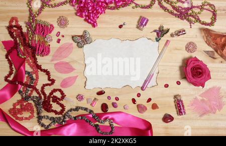 Pink and Magenta Jewelry With Rose and Blank Paper With Burned Edges Stock Photo
