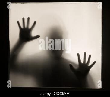 Shadowy figure behind glass - horror background Stock Photo