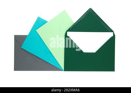 Envelopes of green hues with blank white card Stock Photo