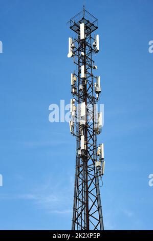 cell phone tower on a blue sky background Stock Photo