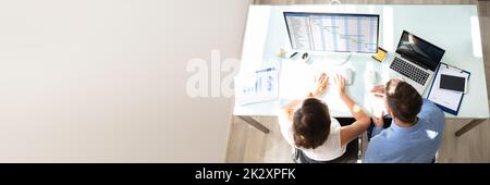 Two Businesspeople Analyzing Gantt Chart On Computer Stock Photo