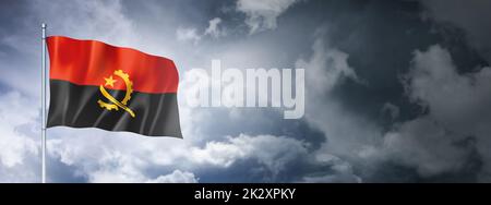 Angolan flag on a cloudy sky Stock Photo