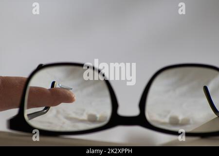 Blue contact lens through black eyeglasses shows different eyewear to correct farsightedness and nearsightedness by optometry or eye doctor against myopia with visual eye correction for perfect vision