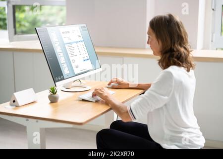 Accountant Using E Invoice Software At Computer Stock Photo