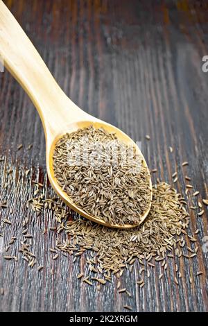 Cumin seeds in spoon on table Stock Photo