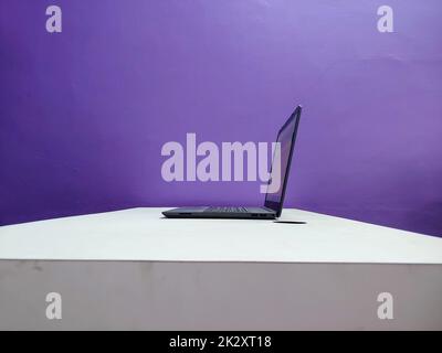 A working laptop on a table Stock Photo