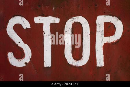 word stop written with paint on red rusted metallic plate Stock Photo