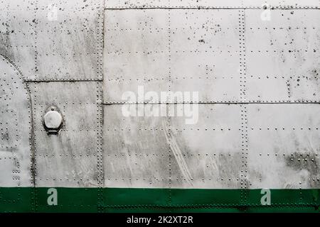 metal airplane hull plating with rows of rivets Stock Photo