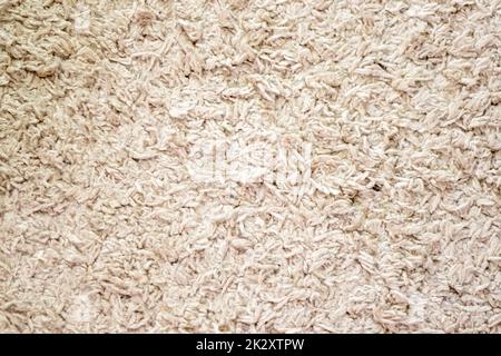 Beige background texture of towel or home carpet. Top view, flat lay. Textile texture of carpet. White or cream pile carpet. Stylish carpet on the floor in the room. Interior Design. Stock Photo