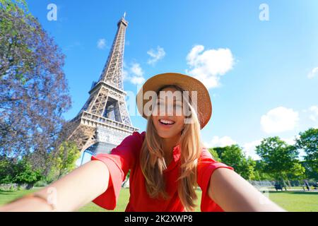 Selfie girl in Paris, France. Young tourist woman taking self portrait with Eiffel Tower in Paris. Stock Photo