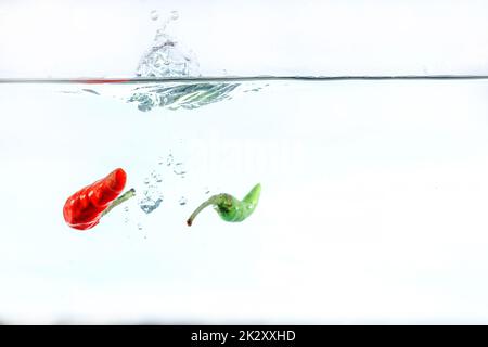 Red chilli, water splashes, solated on a white background Stock Photo